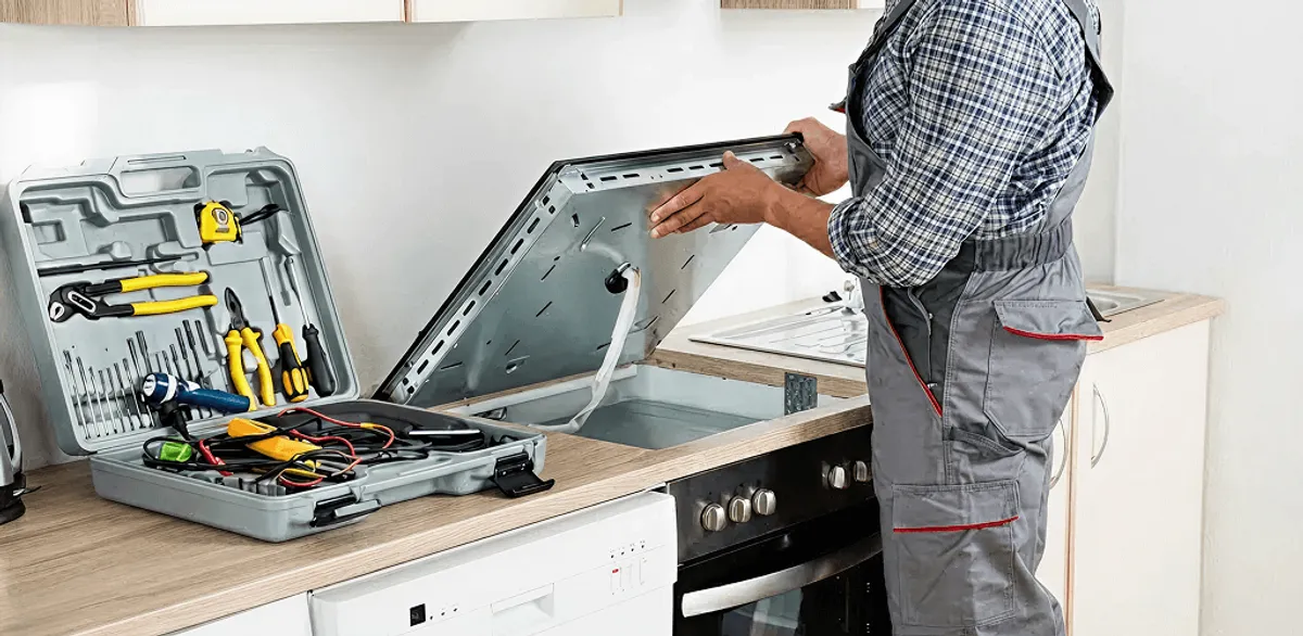 Handyman repairing a cooktop and checking wiring connections in Wichita, KS