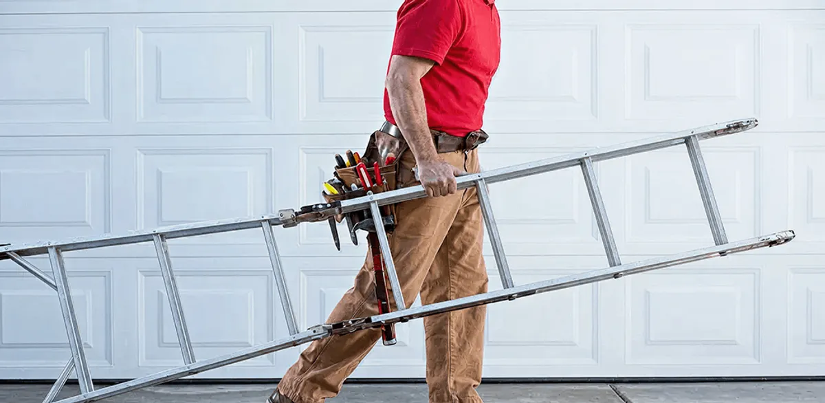Garage door repair technician arriving with tools and ladder in Wichita, KS