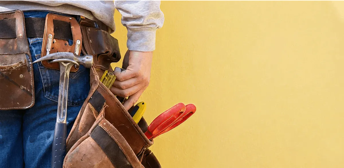 Handyman with tool belt ready for home repairs and maintenance in Wichita, KS