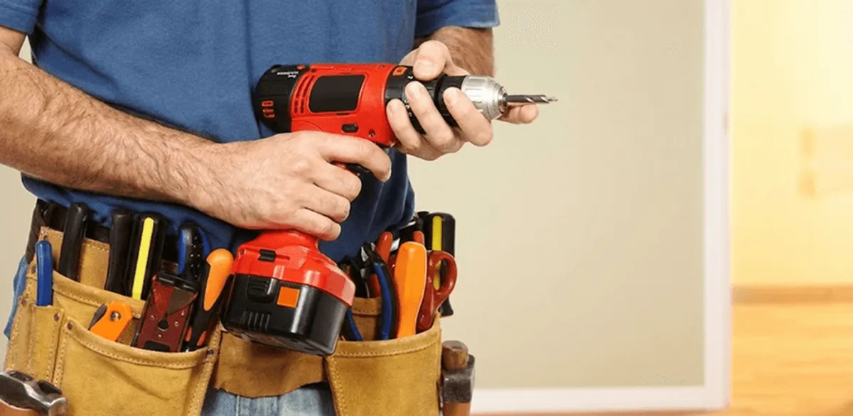 Handyman holding a power drill for home repairs and installations in Wichita, KS